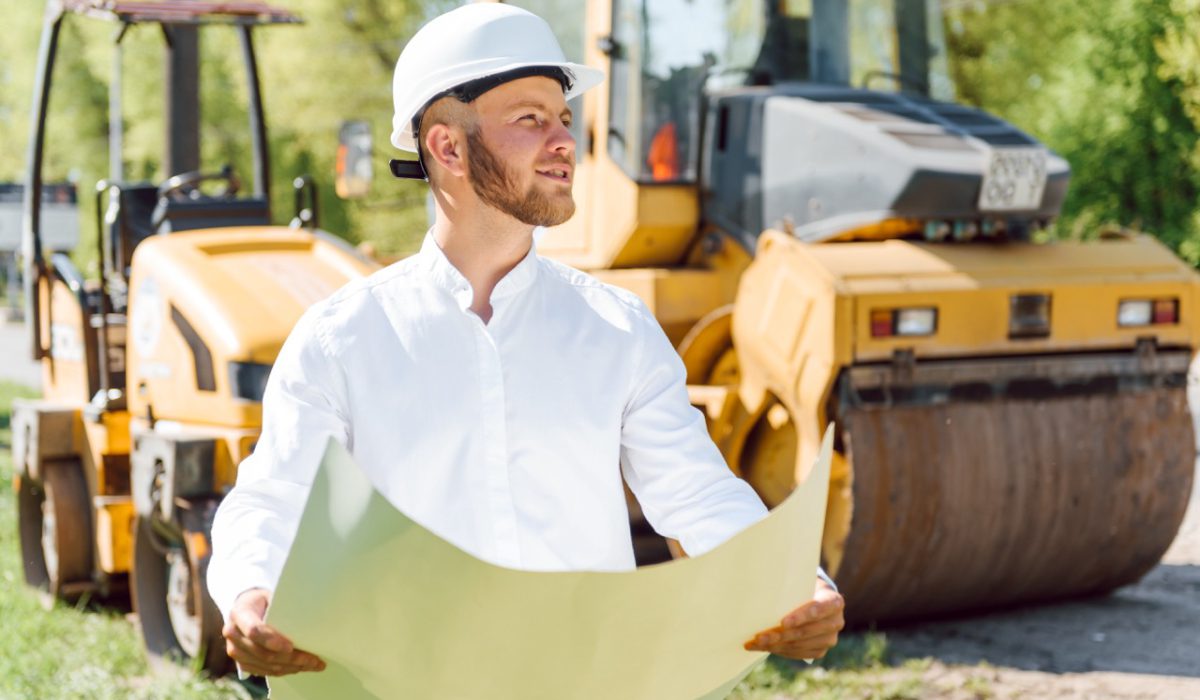 Civil engineering, road construction. The concept of building a new asphalt road. Road repair. Road service worker near the rink.